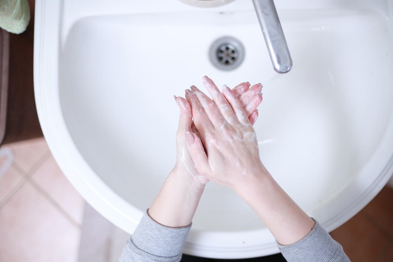 Person experiencing symptoms of obsessive-compulsive disorder in a focused, repetitive moment