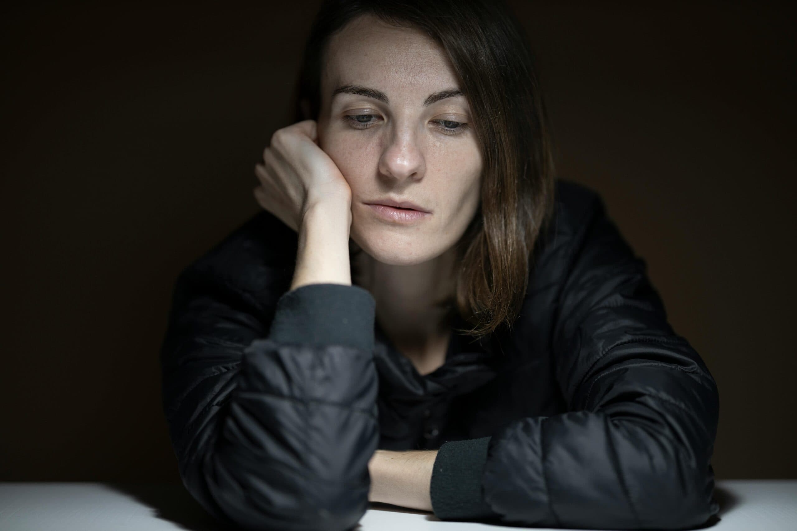 Person experiencing symptoms of depression in a quiet, reflective moment