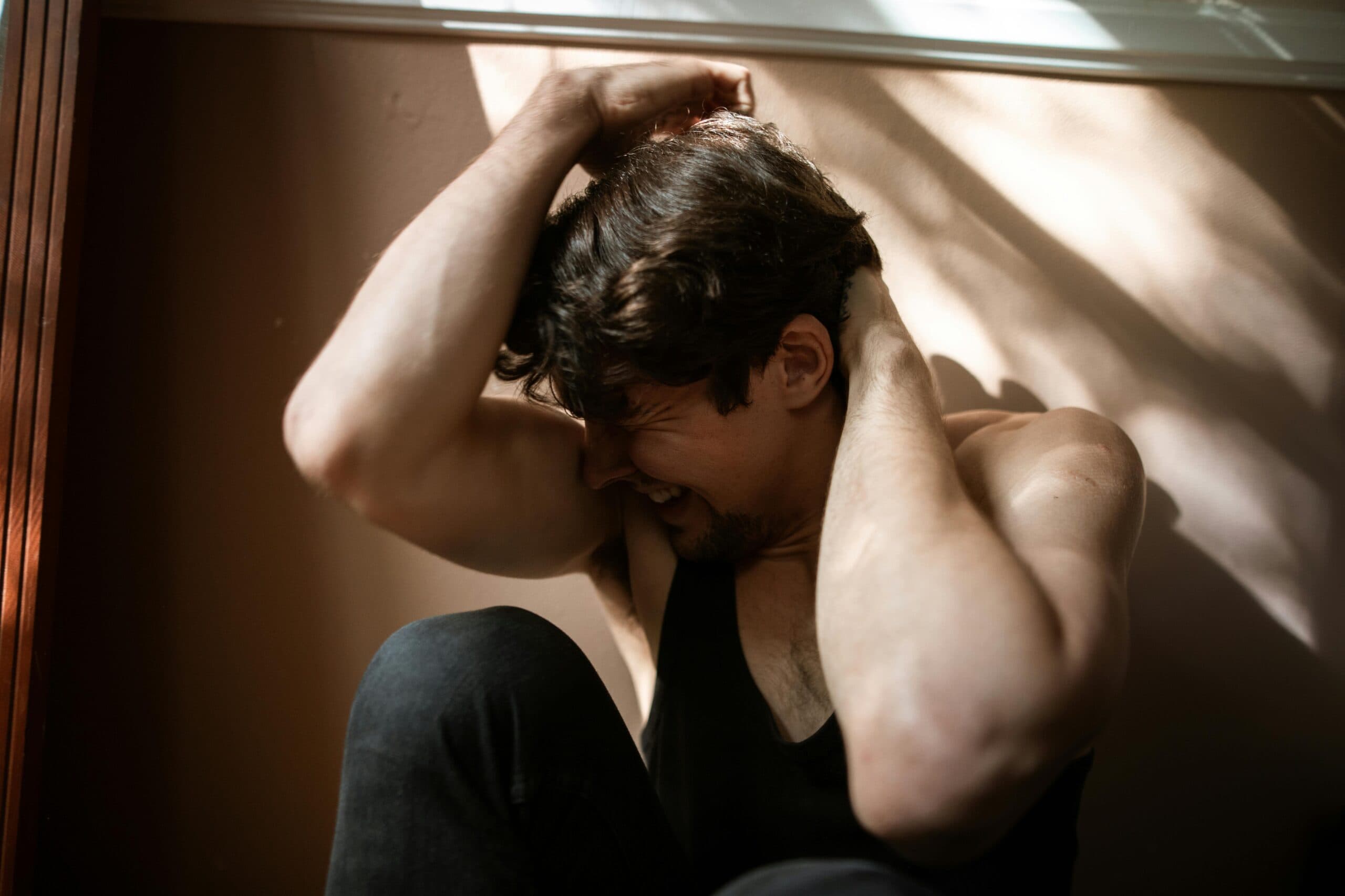 Person experiencing symptoms of post-traumatic stress disorder in a moment of distress